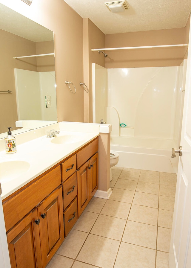 full bathroom featuring tile patterned flooring, toilet, vanity, a textured ceiling, and  shower combination