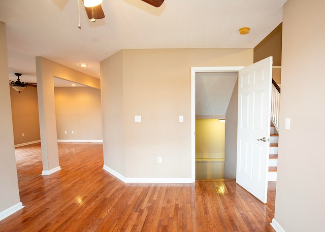 empty room with hardwood / wood-style flooring and ceiling fan