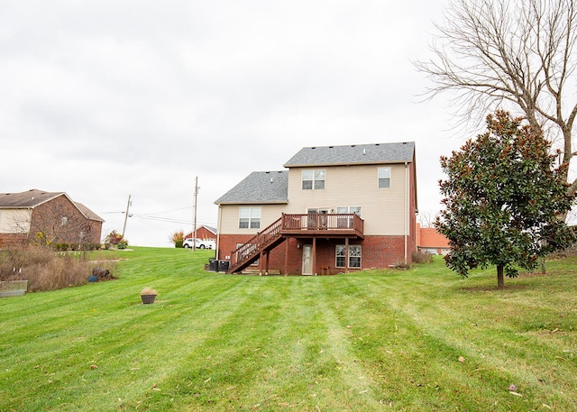 rear view of property featuring central air condition unit, a deck, and a yard