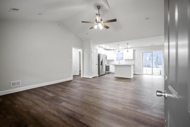 unfurnished living room featuring vaulted ceiling, hardwood / wood-style flooring, and ceiling fan