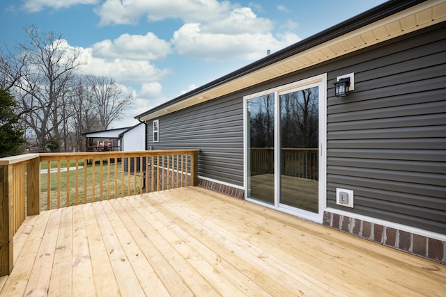 wooden deck featuring a yard