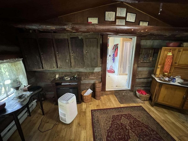 miscellaneous room featuring hardwood / wood-style flooring, lofted ceiling, and wooden walls