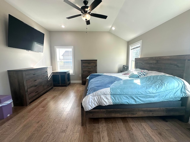 bedroom featuring hardwood / wood-style floors, vaulted ceiling, and ceiling fan