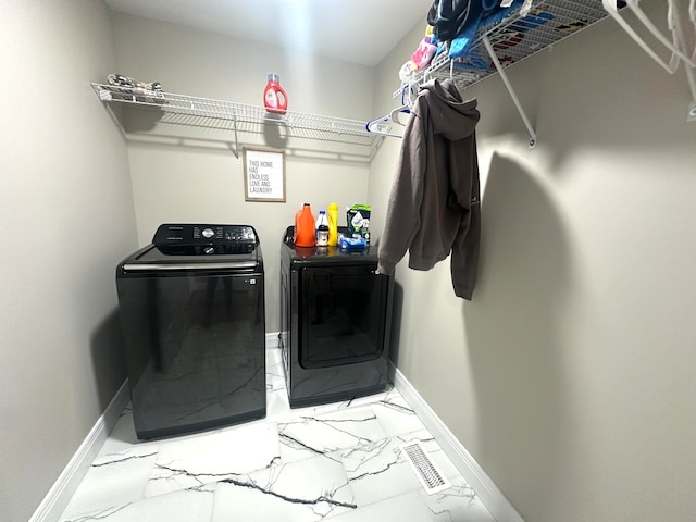 clothes washing area featuring independent washer and dryer