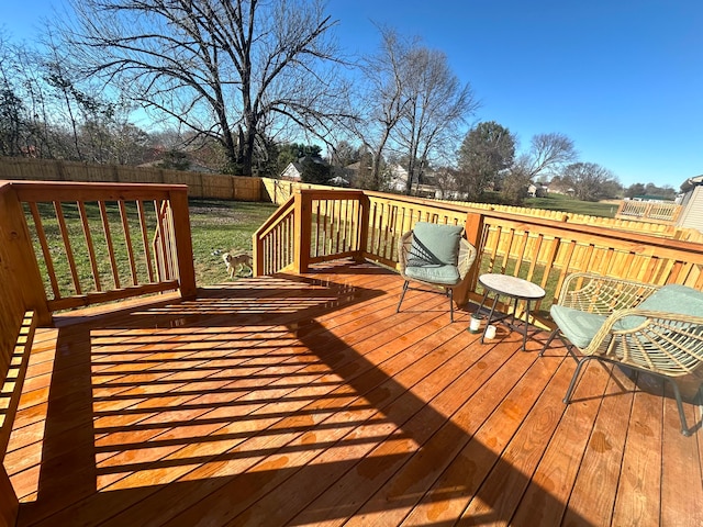 wooden terrace with a lawn