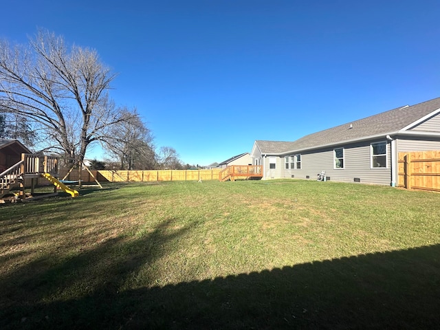 view of yard with a playground and a wooden deck