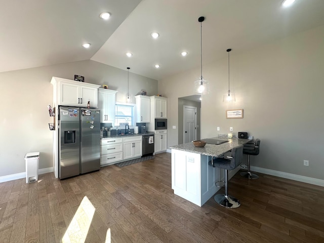 kitchen with white cabinetry, dark hardwood / wood-style floors, and appliances with stainless steel finishes