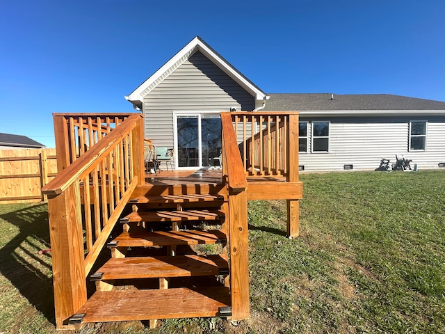 rear view of property with a lawn and a wooden deck