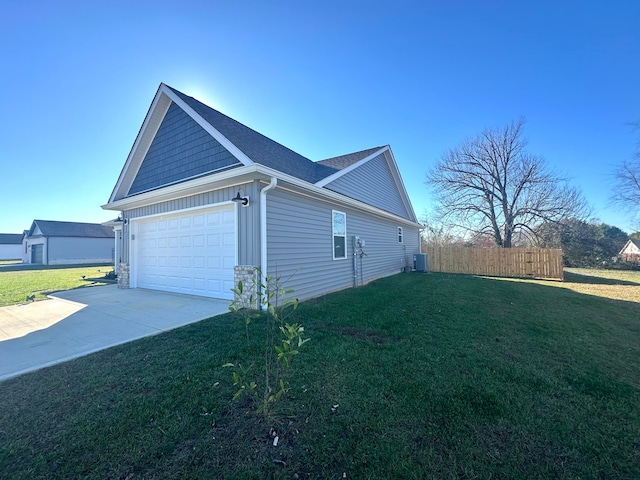 view of property exterior with central AC unit, a garage, and a yard