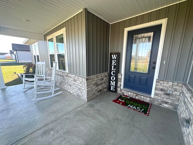 view of exterior entry with covered porch