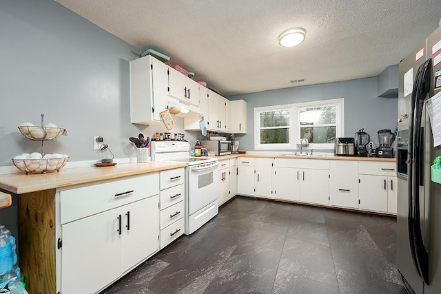 kitchen with kitchen peninsula, appliances with stainless steel finishes, a textured ceiling, sink, and white cabinets