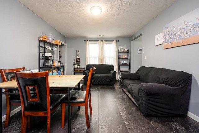 dining area featuring a textured ceiling