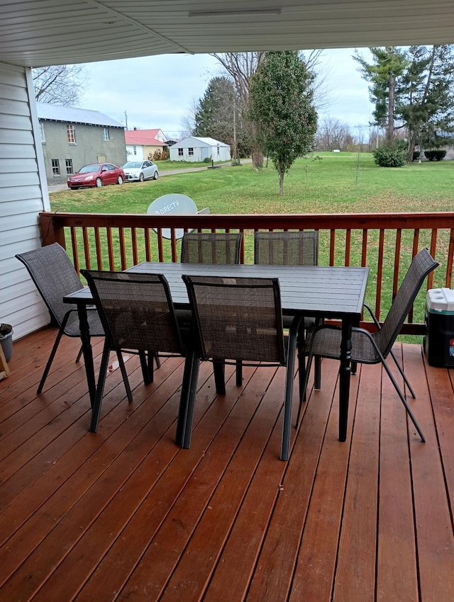 wooden terrace featuring a yard