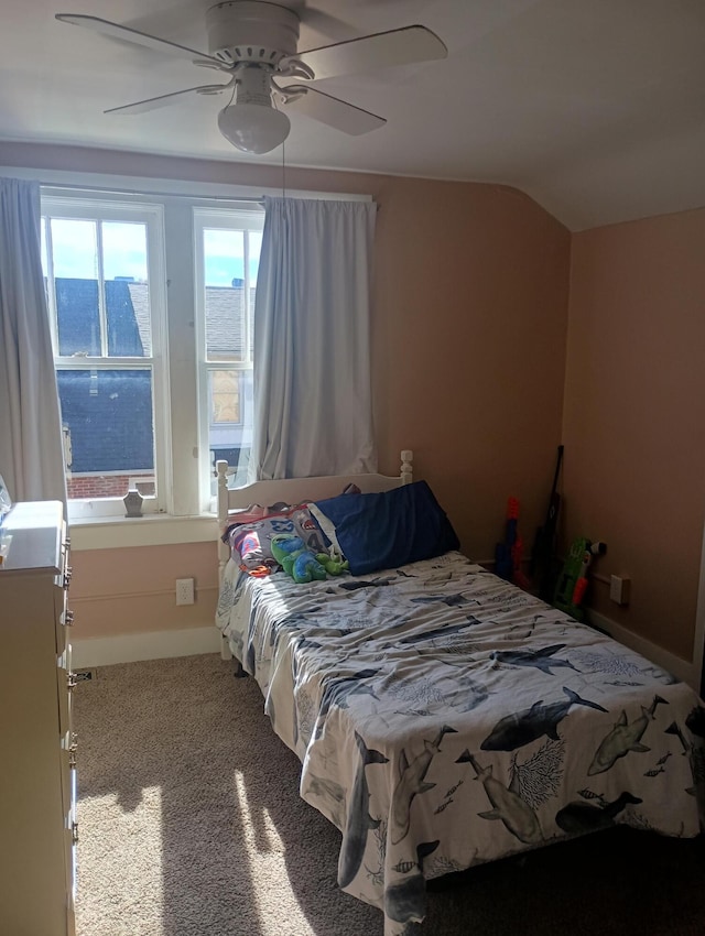 bedroom with ceiling fan, carpet, and vaulted ceiling