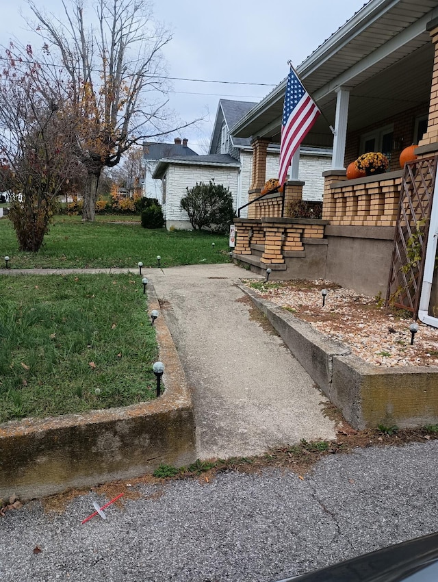 view of yard featuring covered porch