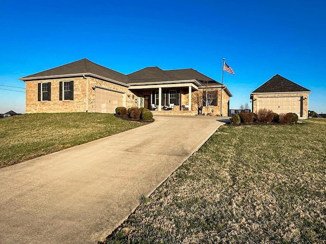 view of front facade with an attached garage, concrete driveway, and a front lawn