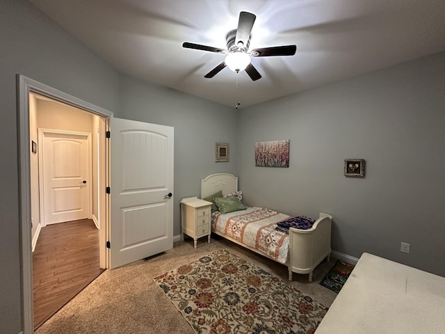 bedroom with ceiling fan and baseboards