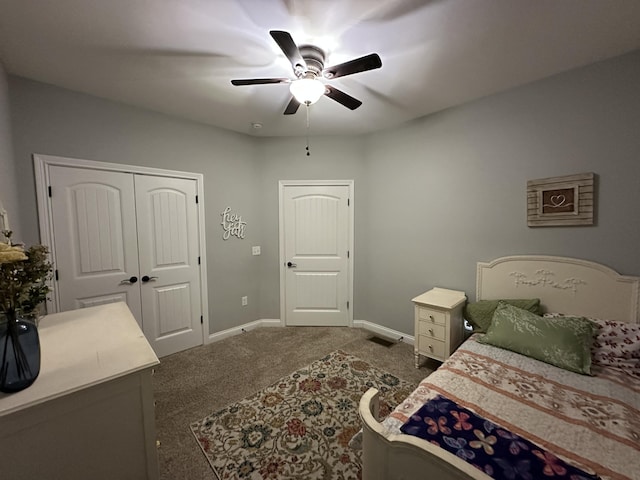 bedroom with visible vents, a closet, carpet, baseboards, and ceiling fan