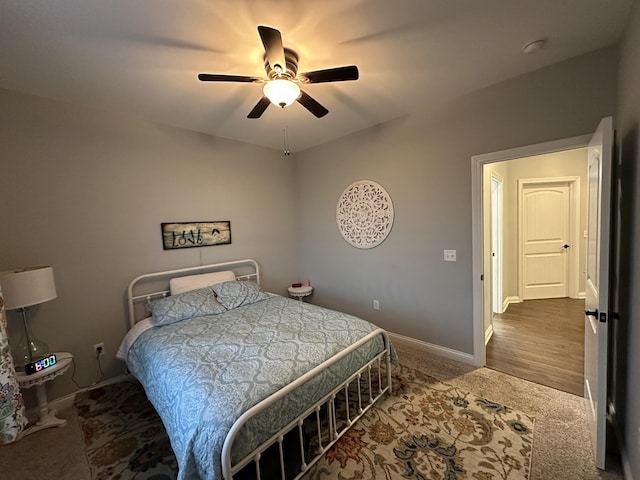 bedroom with carpet flooring, a ceiling fan, and baseboards