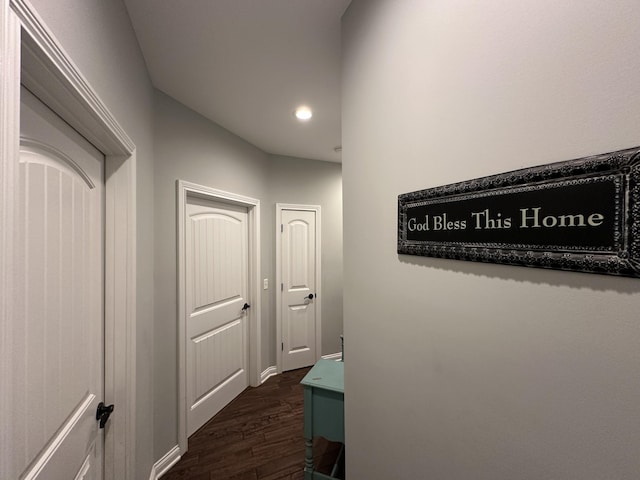 corridor with recessed lighting, dark wood-style flooring, and baseboards