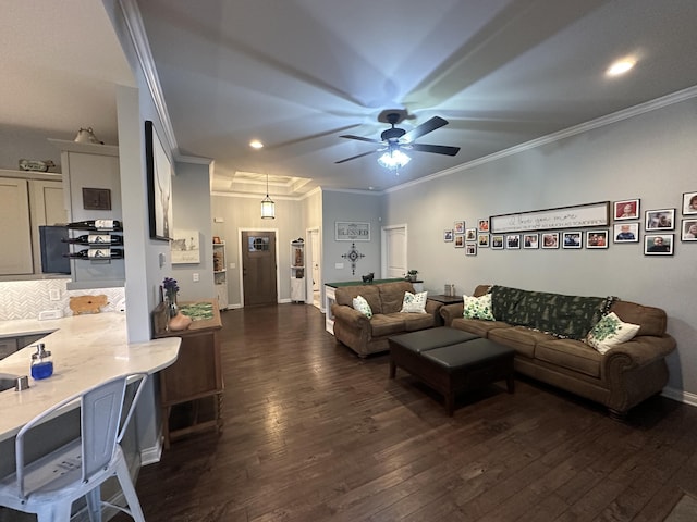 living area with baseboards, dark wood finished floors, recessed lighting, ceiling fan, and ornamental molding