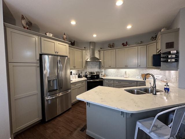 kitchen featuring stainless steel refrigerator with ice dispenser, black electric range, a sink, a peninsula, and wall chimney range hood