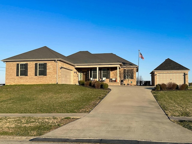 view of front of house featuring brick siding, a garage, a front lawn, and driveway