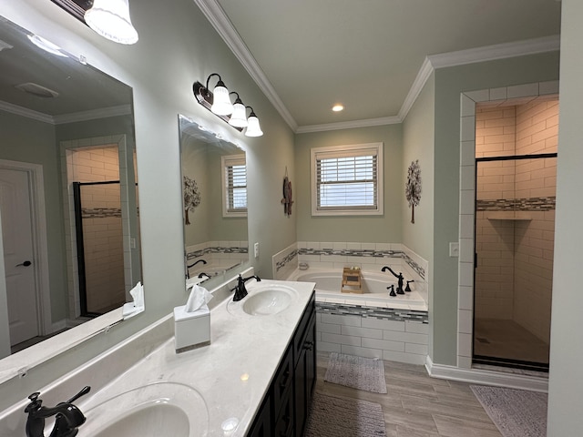 bathroom with a shower stall, crown molding, a garden tub, and a sink