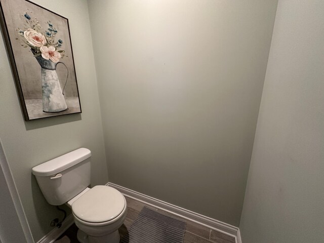 bathroom with visible vents, baseboards, toilet, and wood finished floors