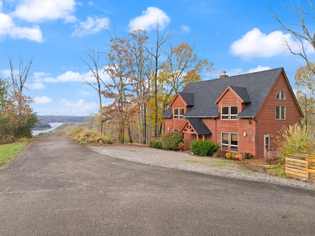 100 Waters Edge Trl, Monticello, KY 42633 - view of front of home featuring a chimney, a shingled roof, a water view, and driveway