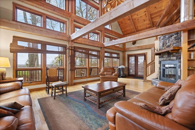 100 Waters Edge Trl, Monticello, KY 42633 - living area with high vaulted ceiling, wood ceiling with exposed beams, hardwood / wood-style floors, and a stone fireplace