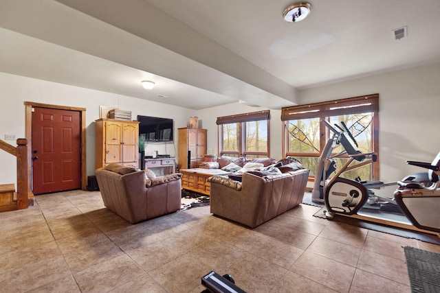 living area featuring light tile patterned floors and visible vents