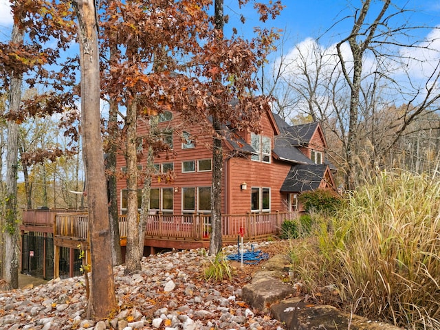 back of house featuring a wooden deck