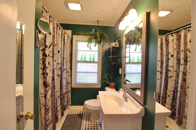 bathroom featuring tile patterned floors, crown molding, a textured ceiling, and toilet