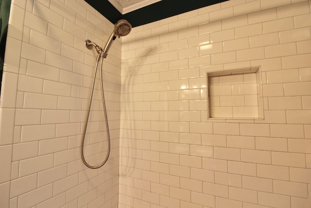 details with a tile shower and ornamental molding