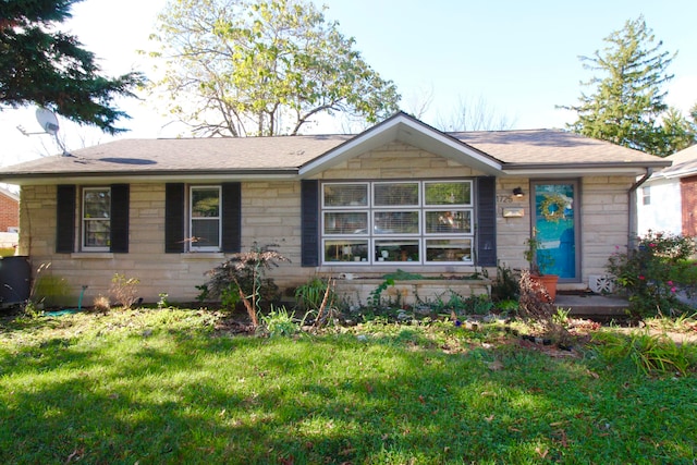 ranch-style home with a front lawn