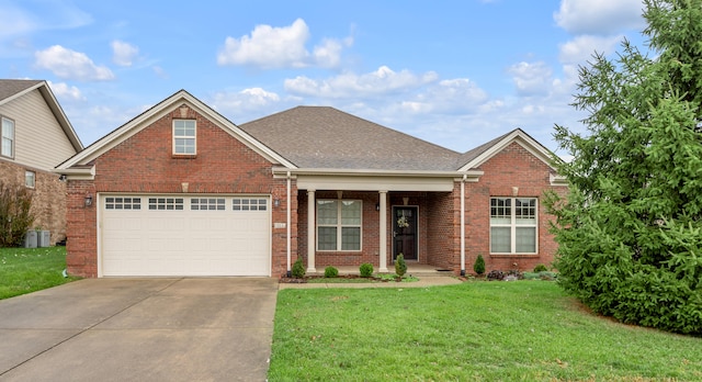 view of front of property with a garage and a front lawn