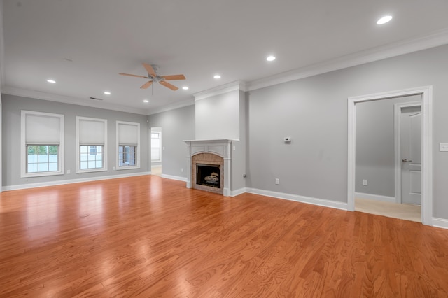 unfurnished living room with crown molding, ceiling fan, and light hardwood / wood-style floors