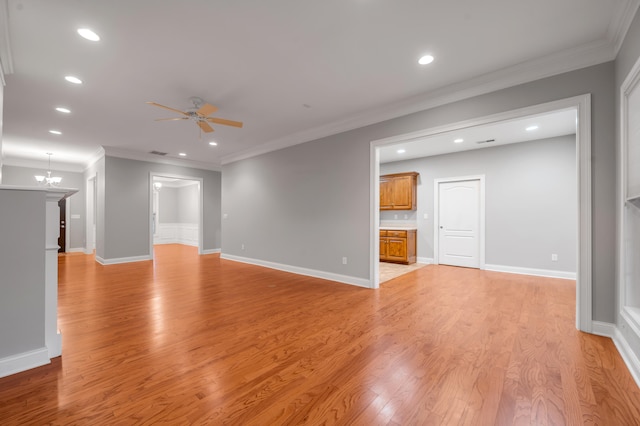 unfurnished living room featuring ceiling fan with notable chandelier, light hardwood / wood-style floors, and ornamental molding