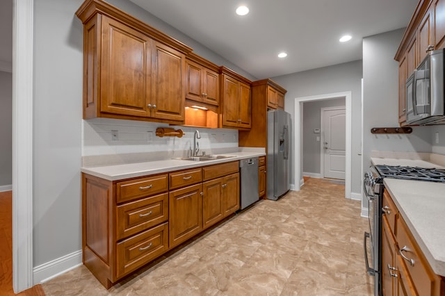 kitchen with decorative backsplash, sink, and stainless steel appliances