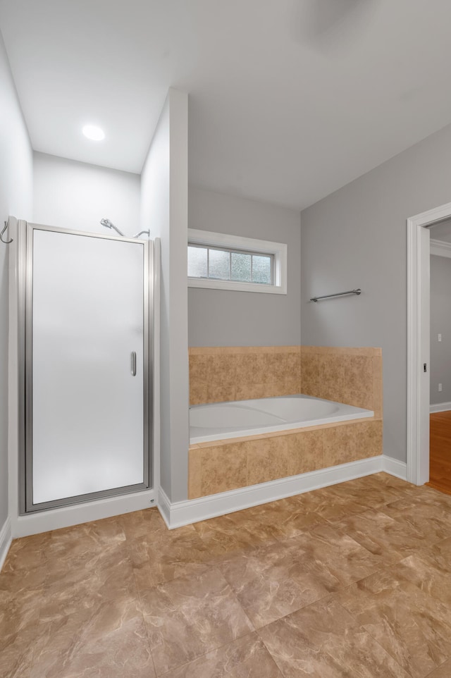 bathroom with separate shower and tub