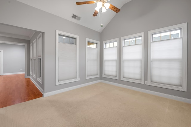 unfurnished room with ceiling fan, light colored carpet, and high vaulted ceiling