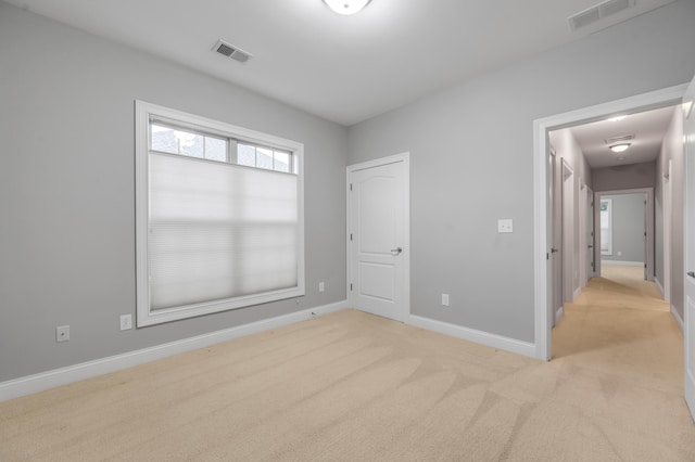 unfurnished bedroom featuring light colored carpet