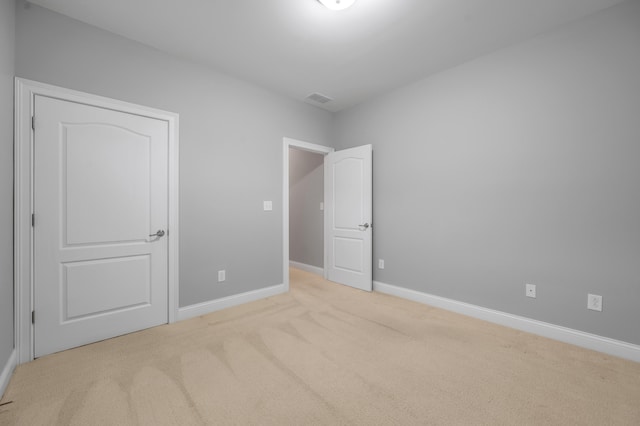 unfurnished bedroom featuring light colored carpet