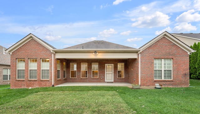 back of property with a patio and a lawn