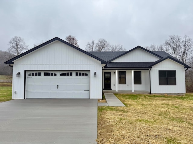 view of front of property with a front yard and a garage