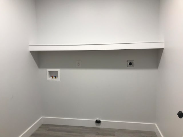 laundry room featuring electric dryer hookup, hookup for a washing machine, and hardwood / wood-style flooring