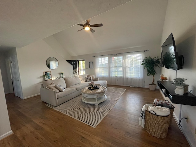 living room featuring ceiling fan, dark wood-type flooring, and high vaulted ceiling