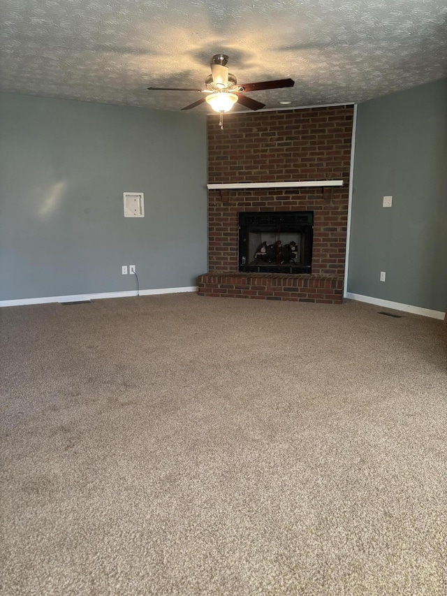 unfurnished living room with a textured ceiling, a brick fireplace, and carpet flooring