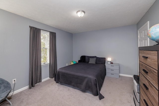 bedroom with light carpet and baseboards